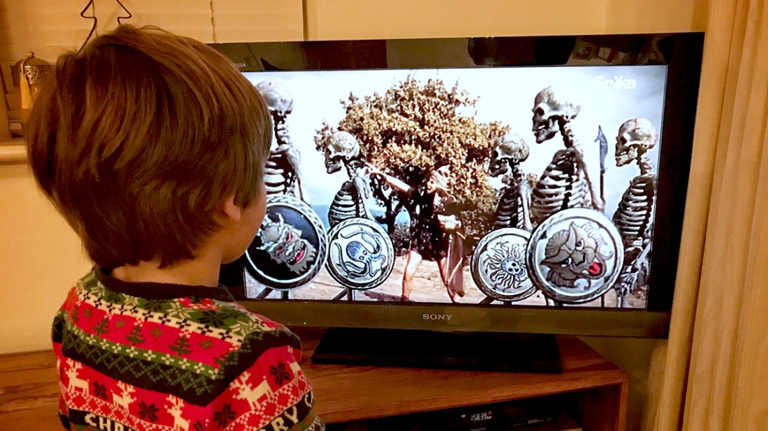 Young boy standing in front of the TV watching Jason and the Argonauts