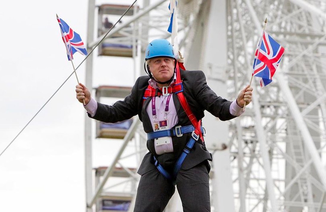 Boris Johnson waving two union flags while stuck on a zip line